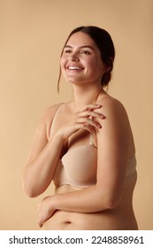 Plus Size Woman. Happy Woman Posing In Beige Lingerie At Studio. Confident Plus Size Lady Smiling Indoors. Love Yourself Concept 