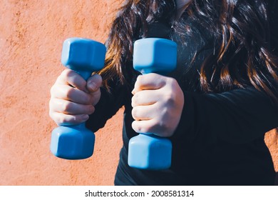 Plus Size Woman Holding Two Blue Dumbells. Healthy Life. Fitness Concept