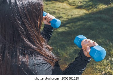 Plus Size Woman Holding Two Blue Dumbells. Healthy Life. Fitness Concept