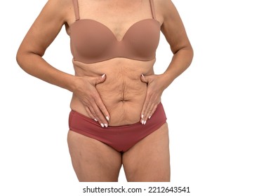 Plus Size Woman Model With Natural Real Body In Underwear Showing Extra Pounds On The Stomach. Female Holding Her Belly. Isolated In White Background.