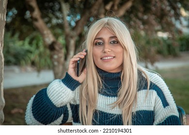 Plus Size Woman With Phone In The Park