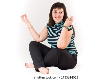 Plus Size Woman Practicing Yoga, Lotus Position, Smiling, Not Looking At The Camera, On A White Background.