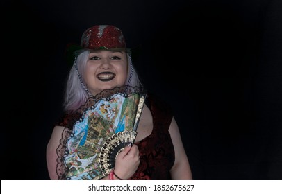 Plus Size Woman With Purple Hair Using Props In A Photo Booth