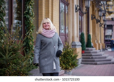 Plus size woman walk on a European old city street and goes shopping for fashion, gift and enjoys. Black Friday, Cyber Monday and Boxing Day, casual clothes for women. Lady thinking about something. - Shutterstock ID 1015725100