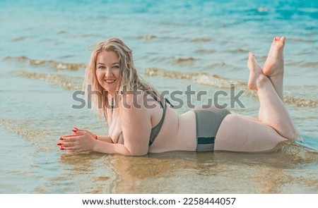 Plus size woman in water in swimsuit. Chubby nice lady, body positive concept, different women sizes