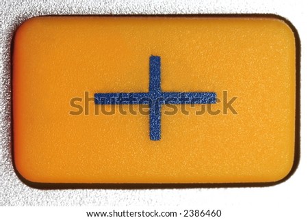 plus symbol on a yellow pressbutton of a pocket calculator