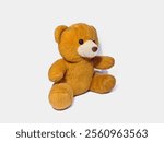 A plush brown teddy bear sitting against a neutral white background. Ideal for concepts of childhood, toys, gifting, and innocence-related stock image needs.