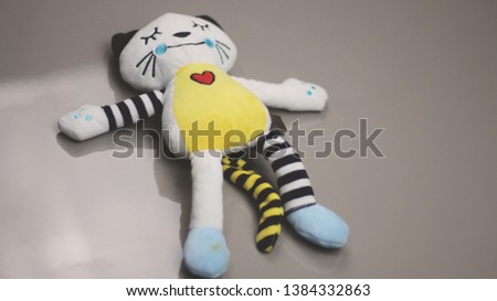 Plush doll lying on the table - toy teddy bear simulating child abuse, rape and kidnapping - child abuse
