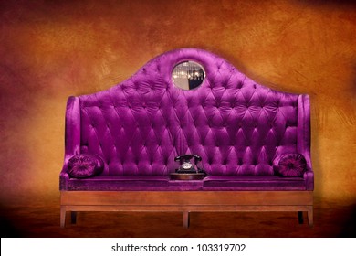 Plush Purple Velvet Loveseat Settee With Antique Style Telephone Against A Textured Background