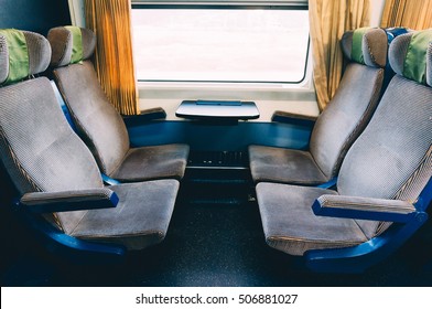 Plush seats inside empty train car. 