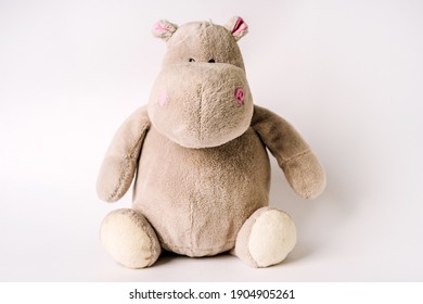 Plush Stuffed Toy Hippo Sits On A White Background