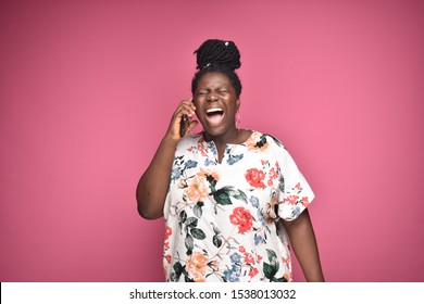 Plus-size African Woman Yelling On Phone. Angry Black Woman Screaming While Making A Phone Call