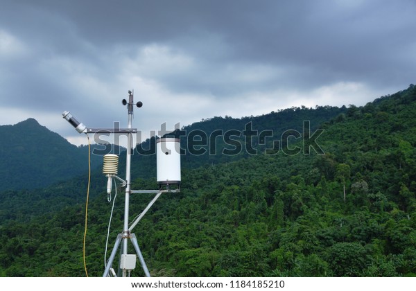 pluviometer or rain gauge in mountain background with\
rain cloud on sky