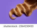 Ply of shiny, healthy, glowing blonde hair with wavy styling on purple background. Professional hair treatment. Concept of hair care, organic products, natural beauty, cosmetics. Ad. Poster.