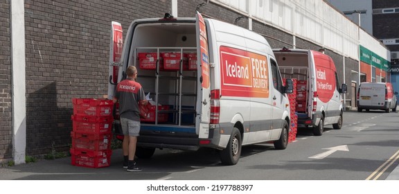 Plymouth, Devon, England, UK. 2022. Grocery And Food Delivery Van Being Loaded With Red Plastic Boxes By A Delivery Driver.