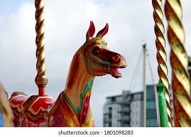 Plymouth England. Close Up Of Single Horse On A Classic Carousel On Twisted Gold Coloured Pole. Very Colourfully Painted.  Stationary. No People.