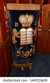 Plymouth England July 2019. Torah Free Standing Wrapped In Blue Velvet  Cloth. Gold Emblems. In Plymouth's Orthodox Synagogue. Oldest Ashkenazi  Synagogue In Regular Use In English Speaking World.