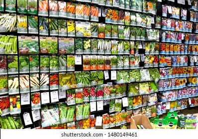 Plymouth England. Retail store interior. Wall full of seeds in colourful packets. Includes flower and vegetable seeds Nine vertical levels of hanging packets. Garden centre.