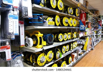 Plymouth England. Retail Store. Shelves Of Electrical Goods And Hardware, Five Shelves High And Full With Products Such As Extension Leads And Three Way Plugs. No People. Wide Walkway.  Small Items. 