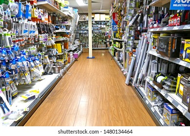 Plymouth England. Retail Store. Shelves Of Electrical Goods And Hardware, Five Shelves High And Full With Products. No People. Wide Walkway.  Small Items. 