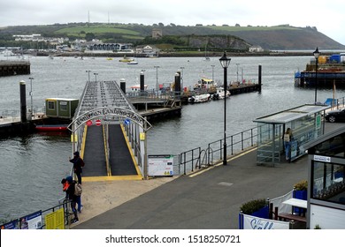 Plymouth England September 30th 2019. The Barbican Landing Stage Showing Metal Gantry Linking Dry Land With Pontoons From Where Pleasure Craft Leave. Mount Batten In Background.