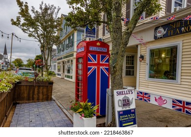 Plymouth, Massachusetts, USA - September 12, 2022: British Style Telephone Booth On Downtown Sidewalk.