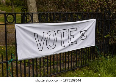 Plymouth, UK. 6:5:2021: An Improvised Sign On A Sheet Reading 'VOTE X' Tied To A Railing In A Park.