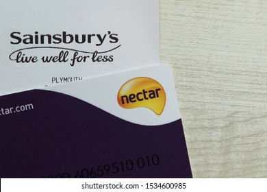 Plymouth,Devon / England - October 18 2019 Nectar Rewards Card On Top Of A Sainsbury's Receipt On A Light Wood Background With Copy Space