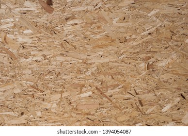 Plywood board texture.  Compressed sawdust panel background. Wood surface for interior design and decoration. - Shutterstock ID 1394054087