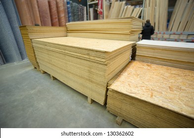 Plywood Of Different Sizes Lie On Racks And Pallets In Build Supermarket