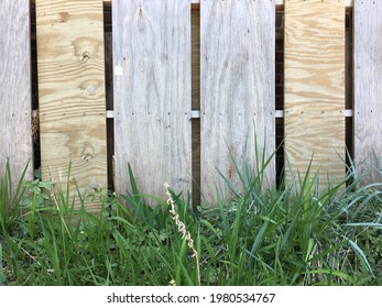 Plywood Fence Made Up Of New And Old Boards