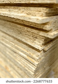 Plywood sheets, OSB sheets from pressed sawdust with selective focus - Shutterstock ID 2268777633