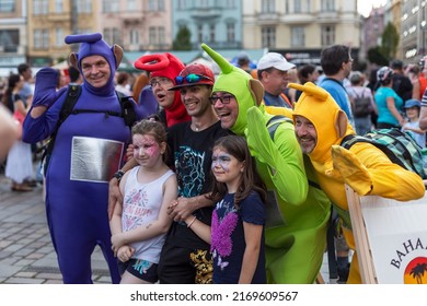 PLZEN, CZECH REPUBLIC - 11. 6. 2022: Historical weekend in Pilsen (Plzeň). Monster parade. Evening procession of the monsters and ghosts through the historical town. Teletubbies posing with children.
