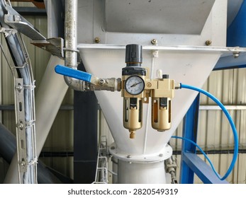 Pneumatic filter regulator installed on a feed processing machine.