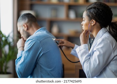 Pneumonia, Bronchitis, Coronavirus, Lungs Diseases Concepts. Black Woman General Practitioner Checking Sick Man Lungs With Stethoscope, Ill Patient Coughing While Having Checkup With Doctor, Side View