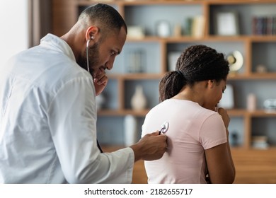 Pneumonia, Bronchitis, Coronavirus, Lungs Diseases Concepts. Arab Man General Practitioner Checking Sick Black Woman Lungs With Stethoscope, Ill Patient Coughing While Having Checkup With Doctor