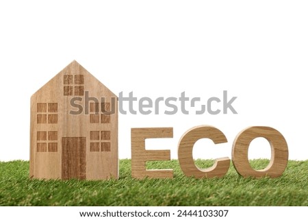 PNG, a wooden house and the word ECO, on the grass, isolated on a white background.