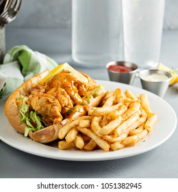 Po boy sandwich with fried shrimp and fries