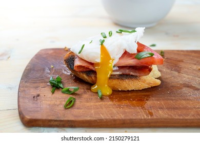 Poached Egg With Dripping Egg Yolk, Ham And Tomato Slice, On Toast Bread, Side View Close Up