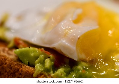 Poached Egg And Smashed Avocado With Chilli Served On Granary Toast