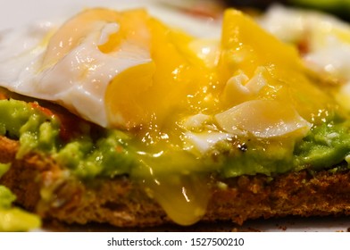 Poached Egg And Smashed Avocado Served On Granary Toast