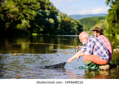 Poachers Fishing. Black Market Caviar. Illegal Hunting Caviar. Extracts Eggs From Sturgeon Caught River. Trap For Fish. Men Sit At Riverside With Fishing Equipment. Poaching Crime And Fishing License.