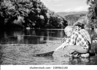 Poachers Fishing. Black Market Caviar. Illegal Hunting Caviar. Extracts Eggs From Sturgeon Caught River. Trap For Fish. Men Sit At Riverside With Fishing Equipment. Poaching Crime And Fishing License.