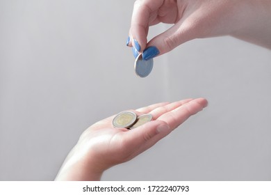 Pocket Money Concept. Woman's Hand Giving Coins To A Child. Money For Kids, Children And Finance. Donation And Charity. Payment And Transfer Currency.