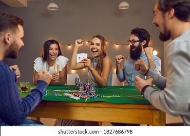 Pocket Rockets. Excited Young Woman Showing 2 Aces While Playing Poker Board Game With Group Of Happy Smiling Friends At Casino Themed Birthday Party At Home Or While Meeting Up In Club At Weekend