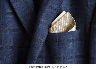 Pocket square with embroidery in the breast pocket of a man's blue suit. Wedding accessories. Lutsk, Ukraine