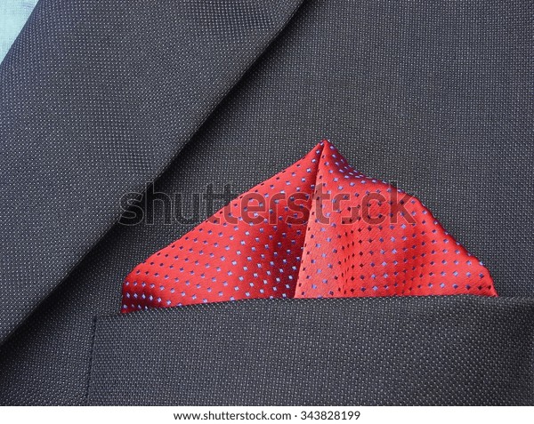 pocket square - handkerchief in the breast pocket\
of a man\'s blue wool\
suit\
