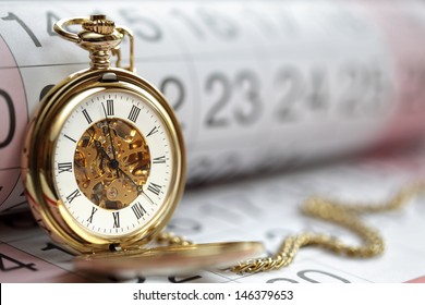 Pocket watch against a calendar concept for planning or scheduling