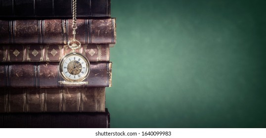 Pocket watch and books background in library or study concept for time - Shutterstock ID 1640099983