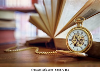 Pocket watch and books in library or study - Powered by Shutterstock